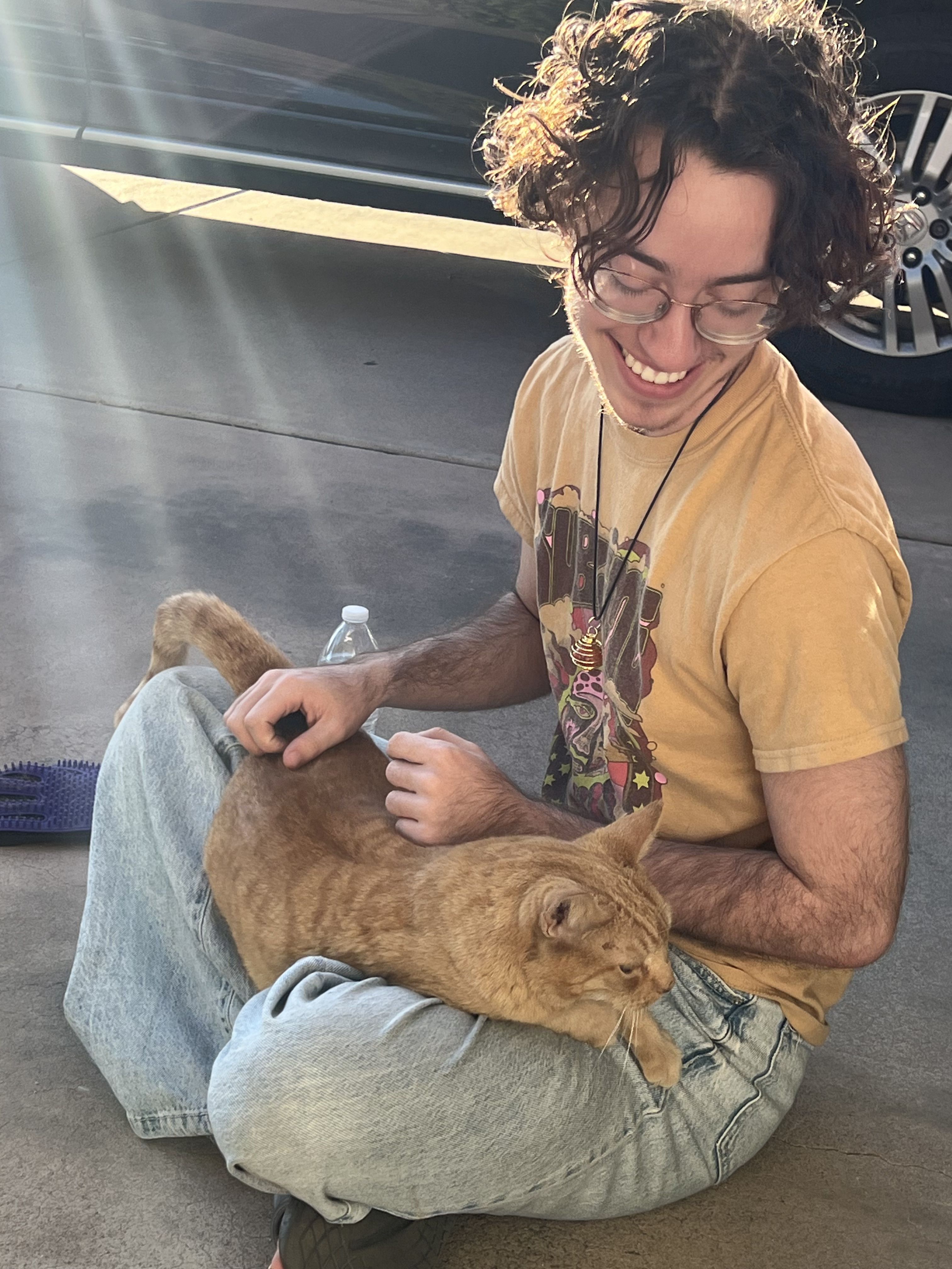 Me sitting with my kitty cat, Tough Guy, in my lap. (He is not tough.)